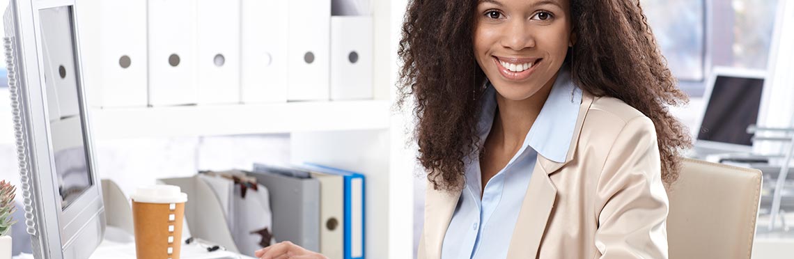 Woman sitting at computer and smiling