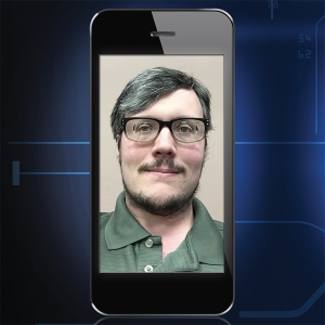 "Frame B" image for "Automeyes" article. Cellphone with a picture of a man wearing glasses.