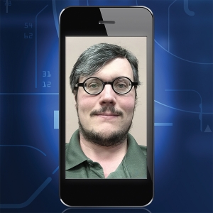 "Frame B" image for "Automeyes" article. Cellphone with a picture of a man wearing glasses.
